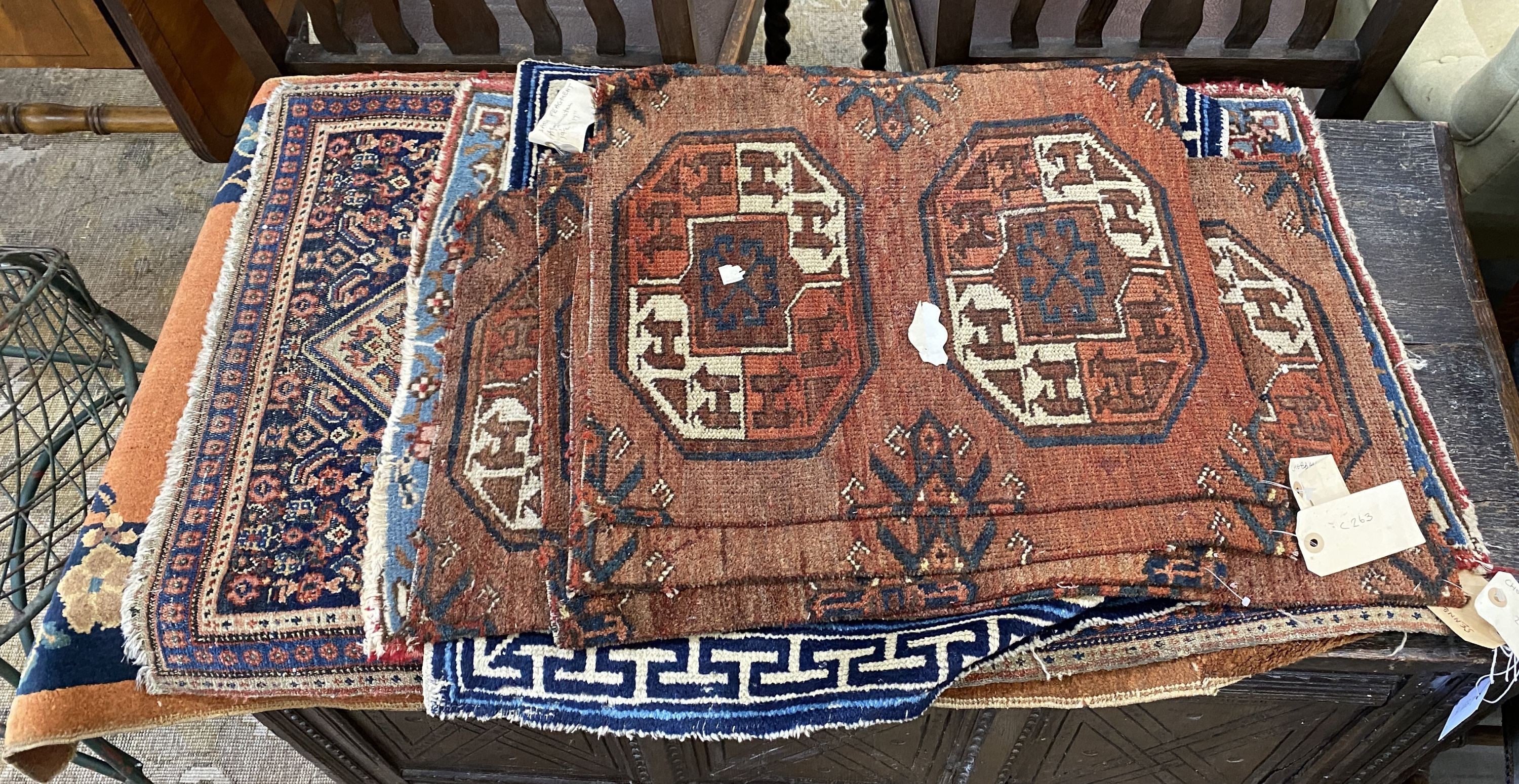 Nine Afghan, Persian and Chinese rug fragments.